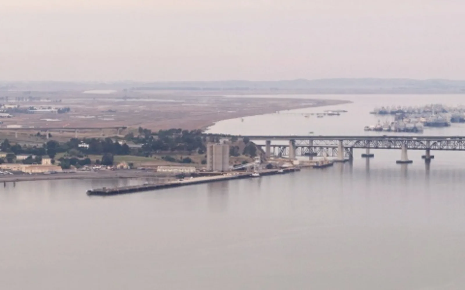 Scenic waterfront shoreline with grassy bluffs and water views of the Carquinez Strait